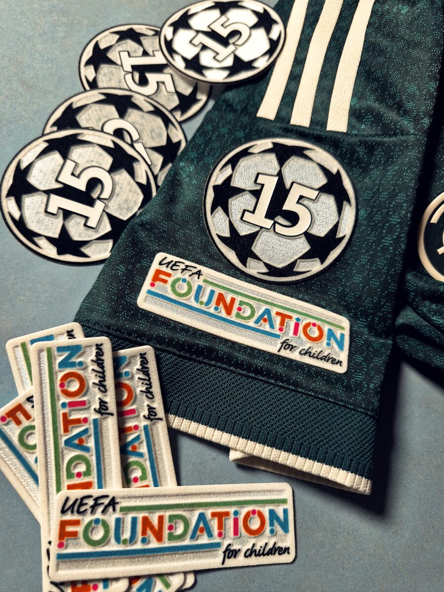 Champions League and UEFA Foundation patches on a shirt sleeve